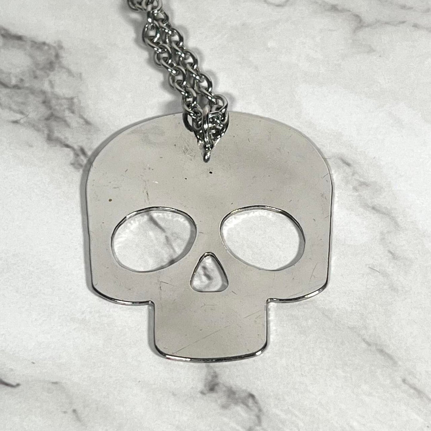 Black and silver sugar skull necklace with a grunge vibe